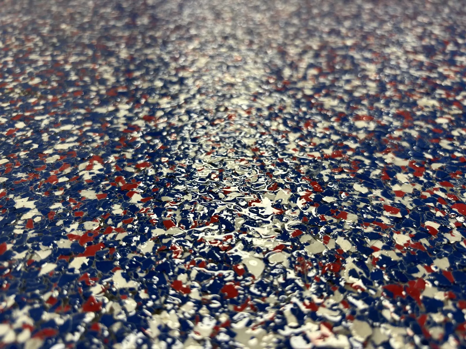Close-up detail of decorative flake texture in a coated floor