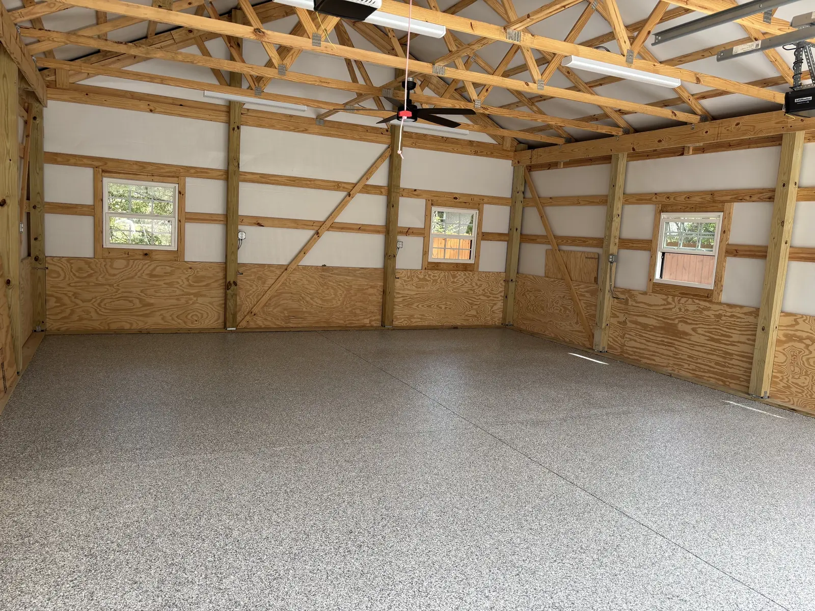 Decorative flake coating installed across a large workshop floor
