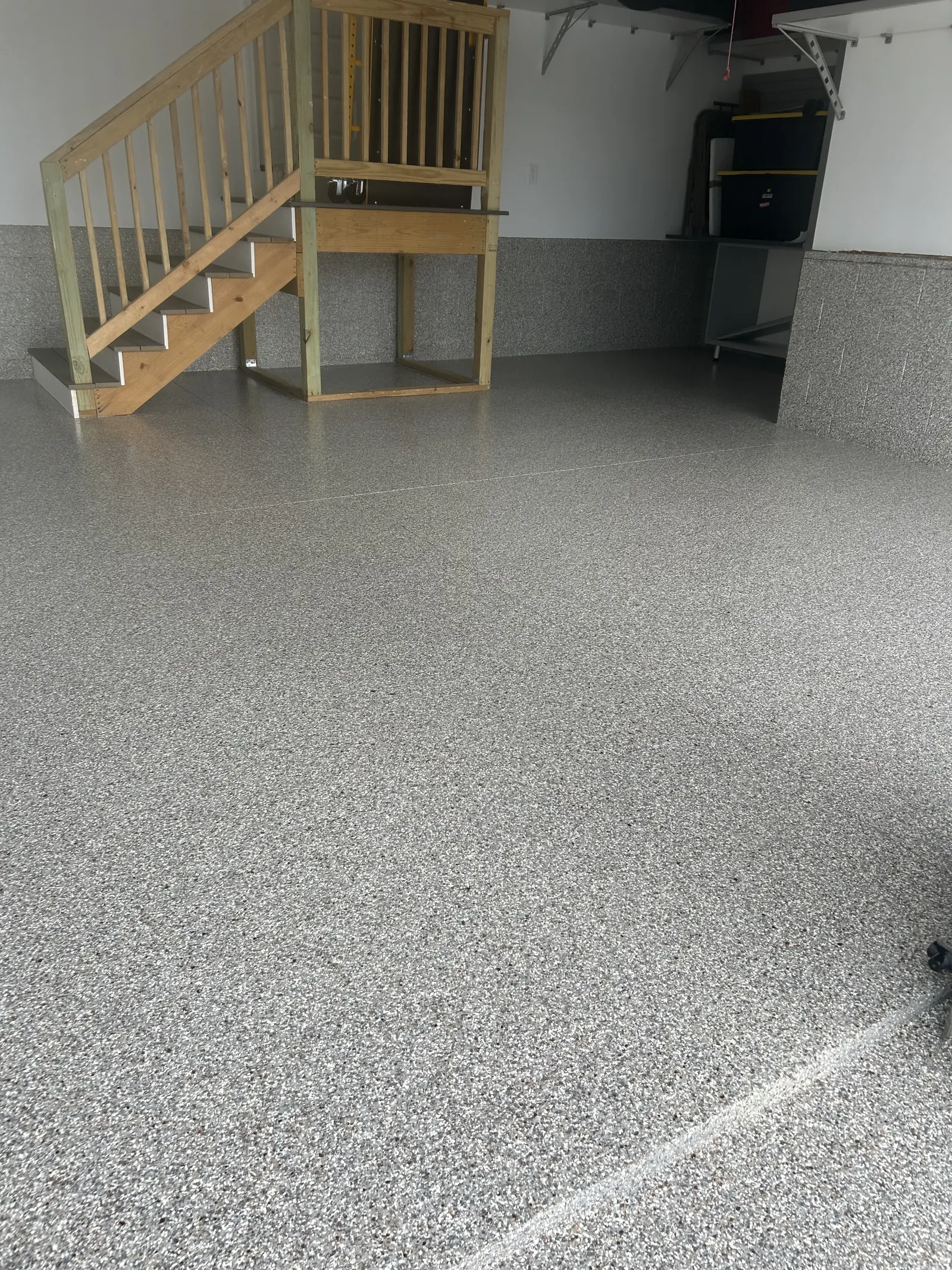 Light gray decorative flake coating in a garage with stairs