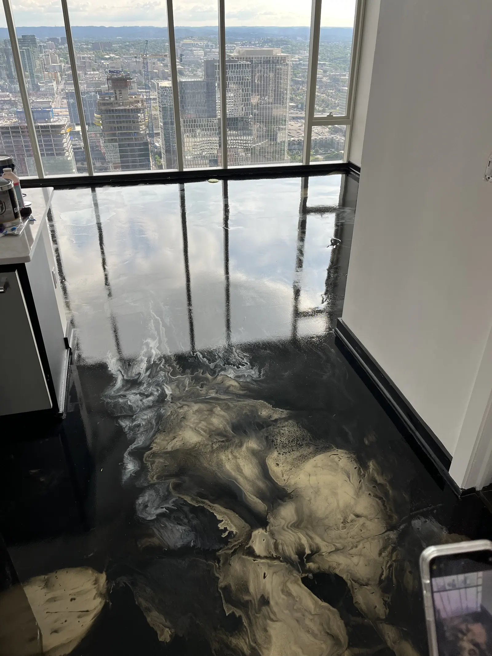 Metallic epoxy floor detail near a window wall